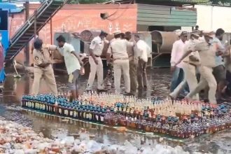 Andhra cops line up seized liquor bottles for destruction, crowd loots them | Video